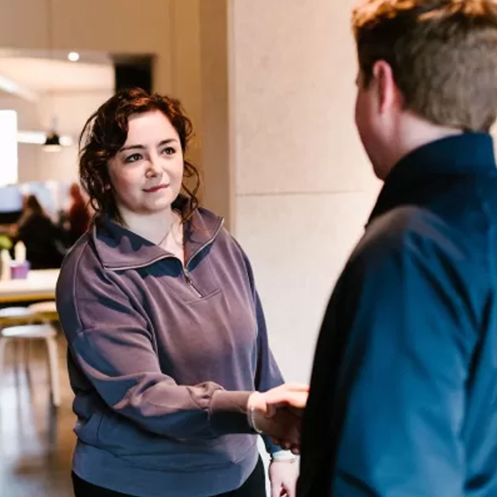 A Campbell Financial adviser meeting a client in the office