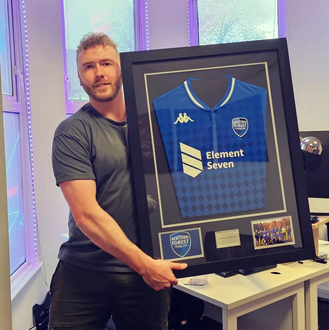 A framed Newtown Forest FC shirt presented to Element Seven as club sponsor