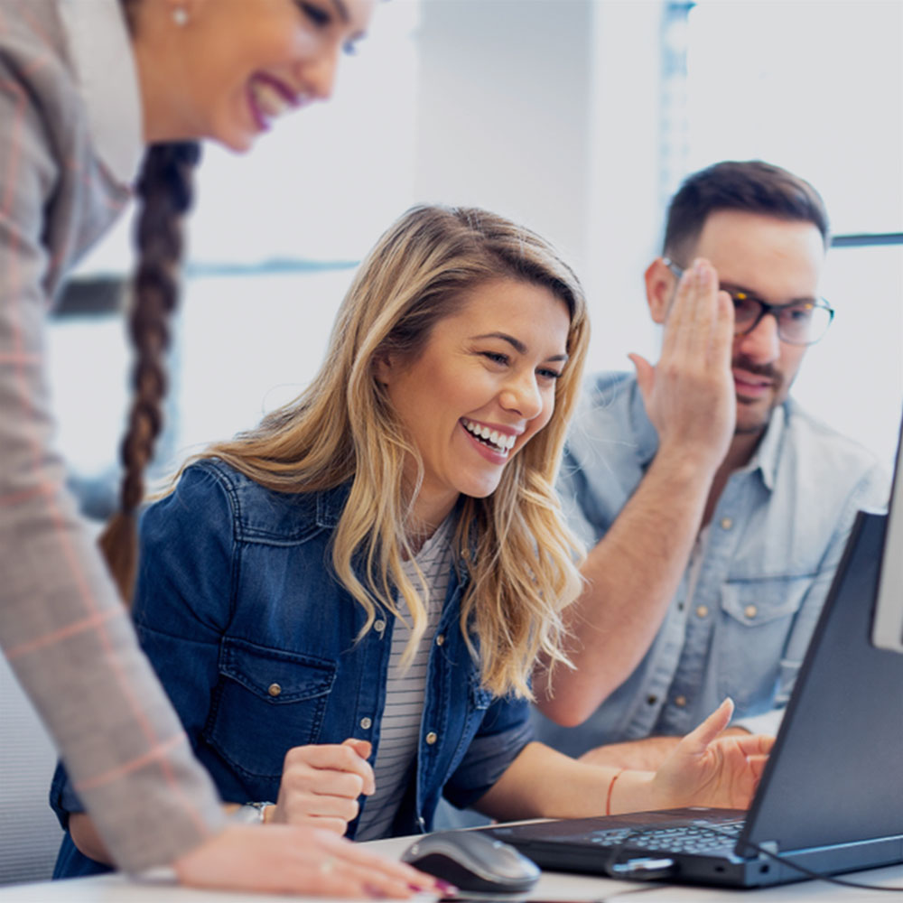 Two colleagues at a laptop in an office