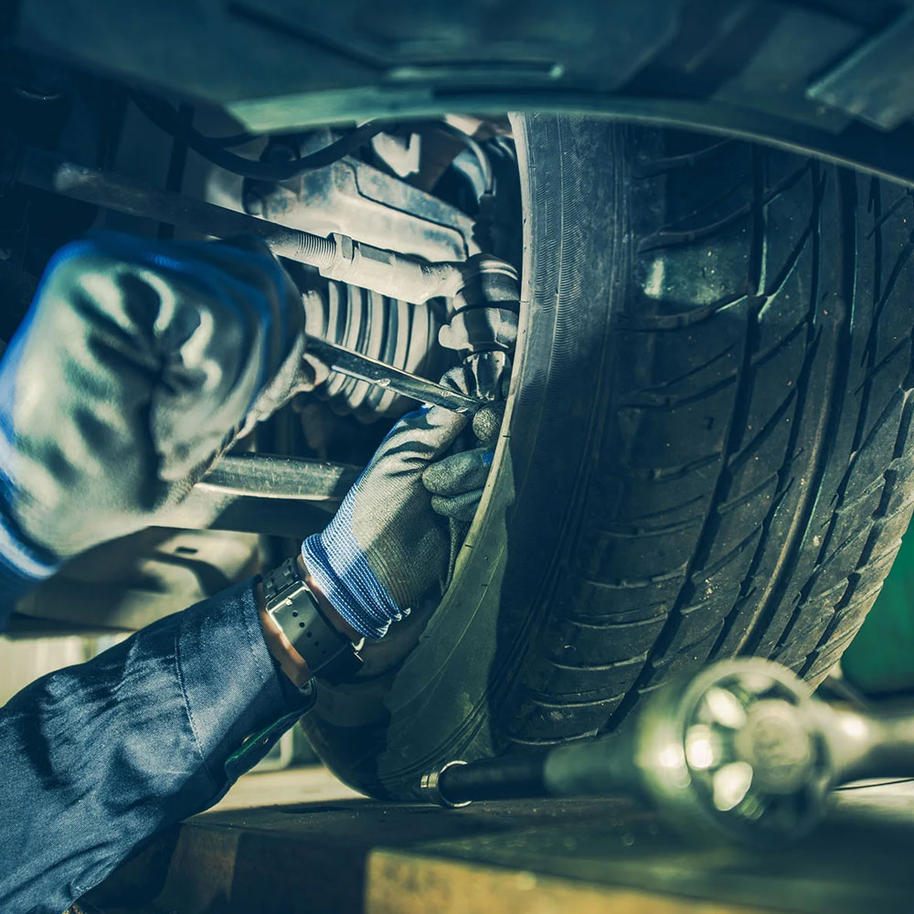 A welder at work wearing protective gloves and a mask